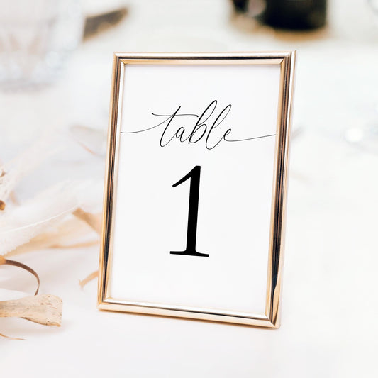 A table number in a frame, with the word &#39;table&#39; in an elegant calligraphy script and a large number one below it.